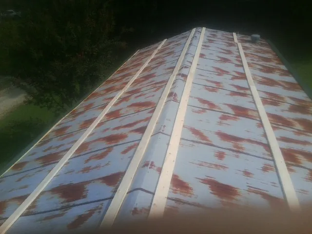 Rusted metal roof panels with new wood purlins before replacement — Storm Damage Roof Repair in Glenelg by Roofing Brothers